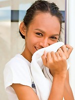 Pretty ladyboy slowly stripping off in a bathroom